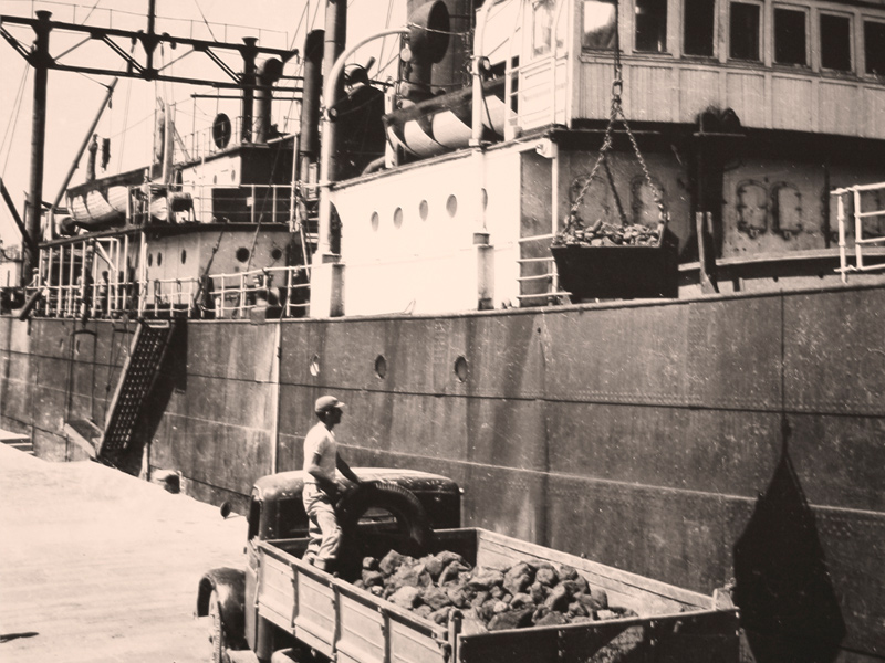 Immagine storica che mostra lo carico della marce da una nave nel porto di piombino